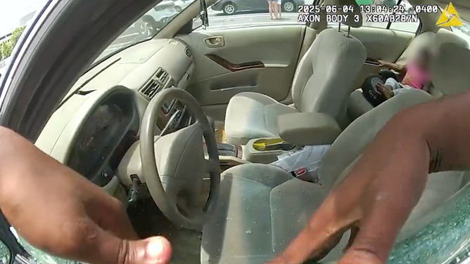A deputy smashed a window in to free the children from the car. The baby girl can be seen in the backseat in this shot.